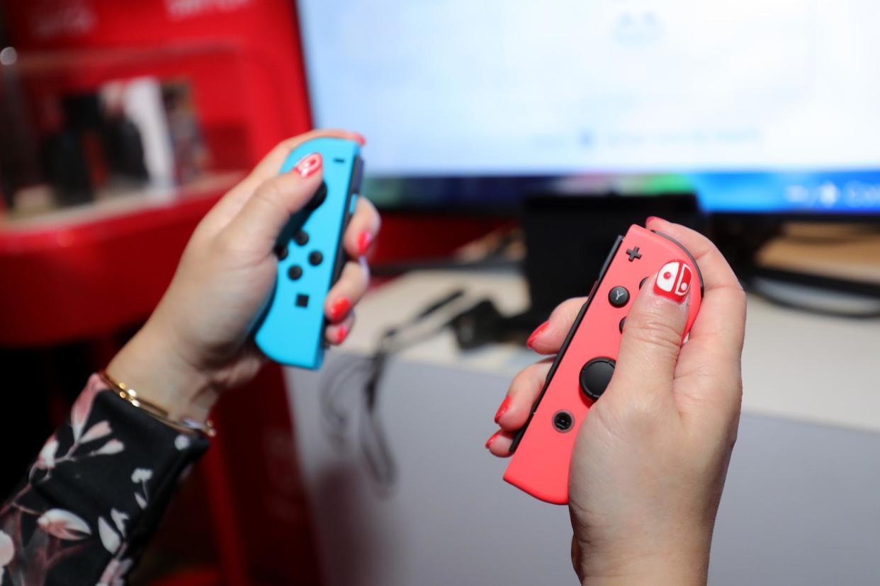 Nintendo of America, A guest enjoys playing Mario Kart 8 Deluxe on the groundbreaking new Nintendo Switch at a special preview event in New York on Jan. 13, 2017: Neilson Barnard/Getty Images for Nintendo of America