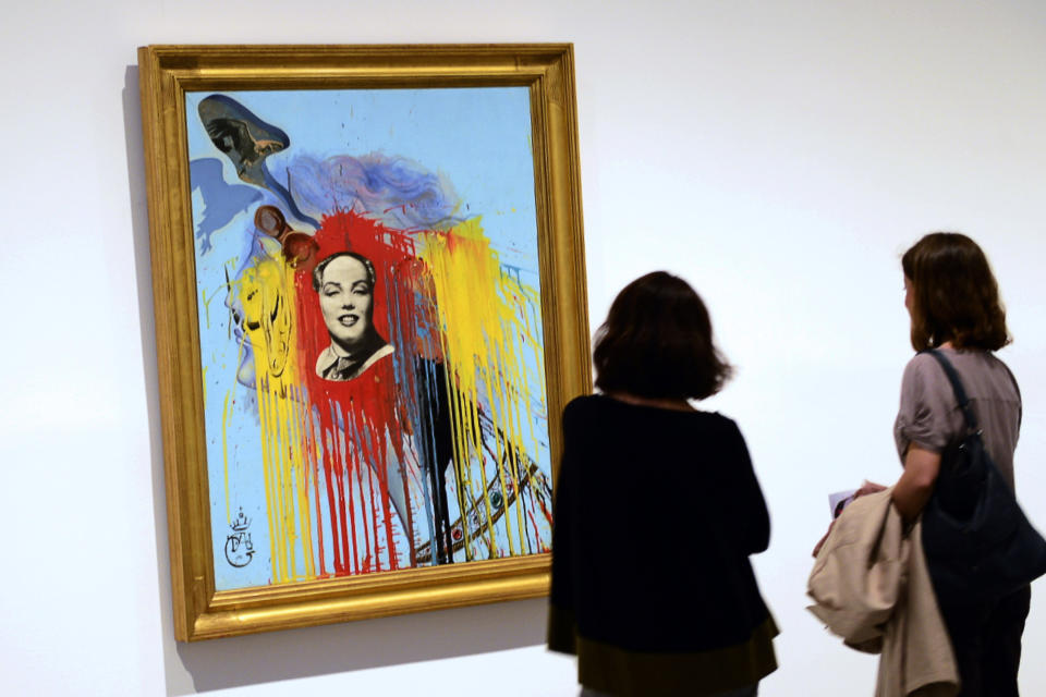 Two women look at a painting entitled 'Autoportrait' (1972) by Spanish surrealist artist Salvador Dali during the exhibition 'Dali. All of the poetic suggestions and all of the plastic possibilities' at the Reina Sofia museum in Madrid on April 25, 2013. (JAVIER SORIANO/AFP/Getty Images)