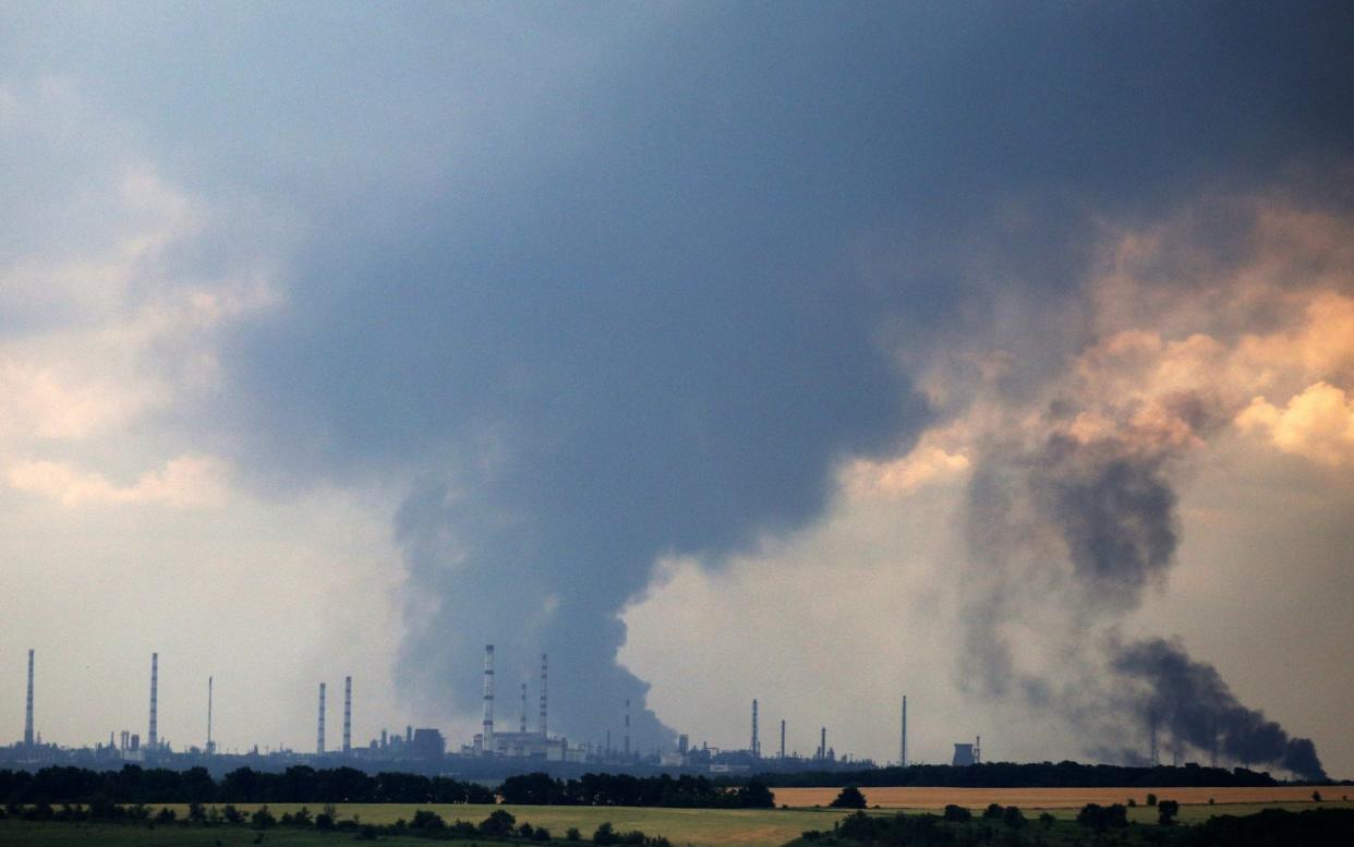 Smoke billows over the oil refinery outside the town of Lysychansk on June 23 - Anatolii Stepanov/AFP