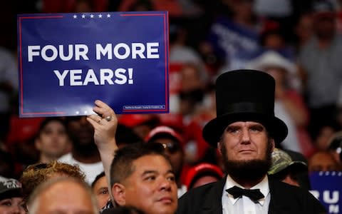 A supporter holds a placard during a campaign rally for U.S. President Donald Trump formally kicking off his re-election bid in Orlando - Credit: Reuters