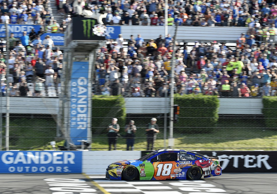 Kyle Busch crosses the finish line to win a NASCAR Cup Series auto race, Sunday, July 29, 2018, in Long Pond, Pa. (AP Photo/Derik Hamilton)