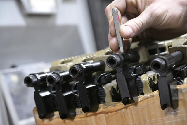 KelTec employee Bobby Cormier proof-stamps 9mm SUB2000 rifles, similar to ones being shipped to Ukraine, at their manufacturing facility on Thursday, March 17, 2022, in Cocoa, Fla. The family-owned gun company was left holding a $200,000 shipment of semi-automatic rifles after a longtime customer in Odessa suddenly went silent during Vladimir Putin’s invasion of Ukraine. Fearing the worst, the company decided to put those stranded 400 guns to good use, sending them to Ukraine's nascent resistance movement. (AP Photo/Phelan M. Ebenhack)