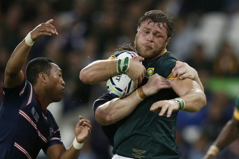 South Africa's number 8 Duane Vermeulen (R) is tackled during a Pool B match of the 2015 Rugby World Cup against USA at the Olympic Stadium, east London, on October 7, 2015