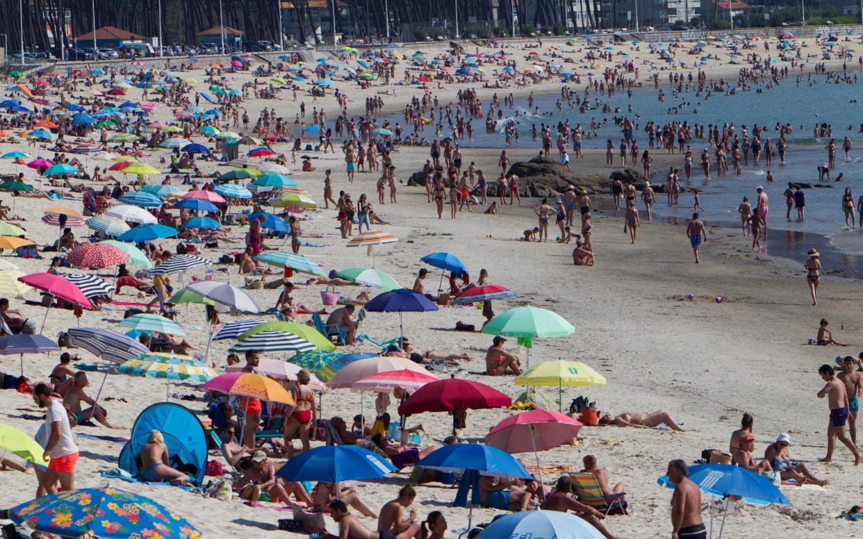 Beachgoers enjoy a warm day at La Fuente beach in Vigo, northern Spain, on Thursday during the first week of phase two - Salvador Sas/EPA-EFE/Shutterstock