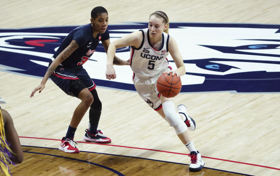 Connecticut guard Paige Bueckers (5) drives the ball against St. John's guard Kadaja Bailey (30) during the first half of an NCAA college basketball game Wednesday, Feb. 3, 2021, in Storrs, Conn. (David Butler II/Pool Photo via AP)