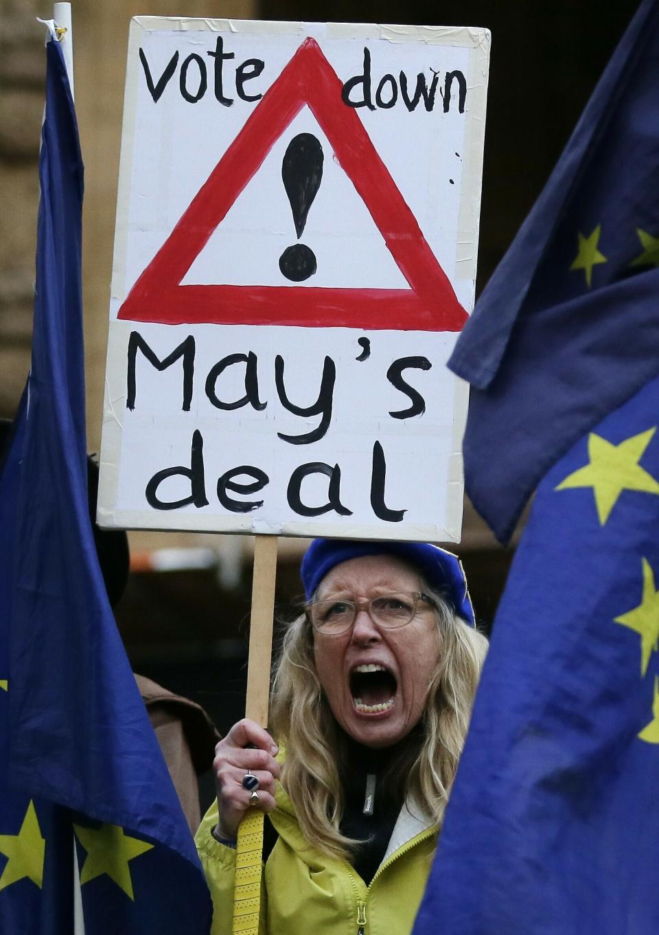 An anti-Brexit pro-remain supporter shouts out during a gathering outside the House of Parliament in London, Tuesday, March 12, 2019. Prime Minister Theresa May's mission to secure Britain's orderly exit from the European Union appeared headed for defeat Tuesday, as lawmakers ignored her entreaties to support her divorce deal and end the political chaos and economic uncertainty that Brexit has unleashed.(AP Photo/Tim Ireland)