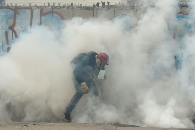 Riot police and pro-government vigilantes fought running battles in Caracas with protesters demanding the ouster of President Nicolas Maduro