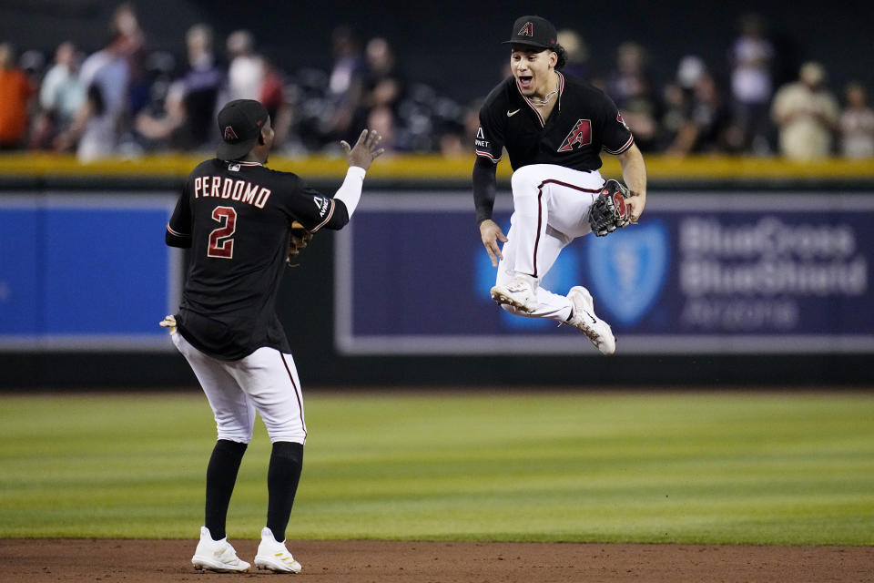 Arizona Diamondbacks center fielder Alek Thomas, right, and shortstop Geraldo Perdomo (2) celebrate the team's 4-2 win against the Baltimore Orioles in a baseball game Friday, Sept. 1, 2023, in Phoenix. (AP Photo/Ross D. Franklin)