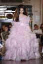 <p>The teenager looked stunning in a feathered pink gown at the Valentino fashion show during Haute Couture AW18/19 in Paris, July 2018</p>