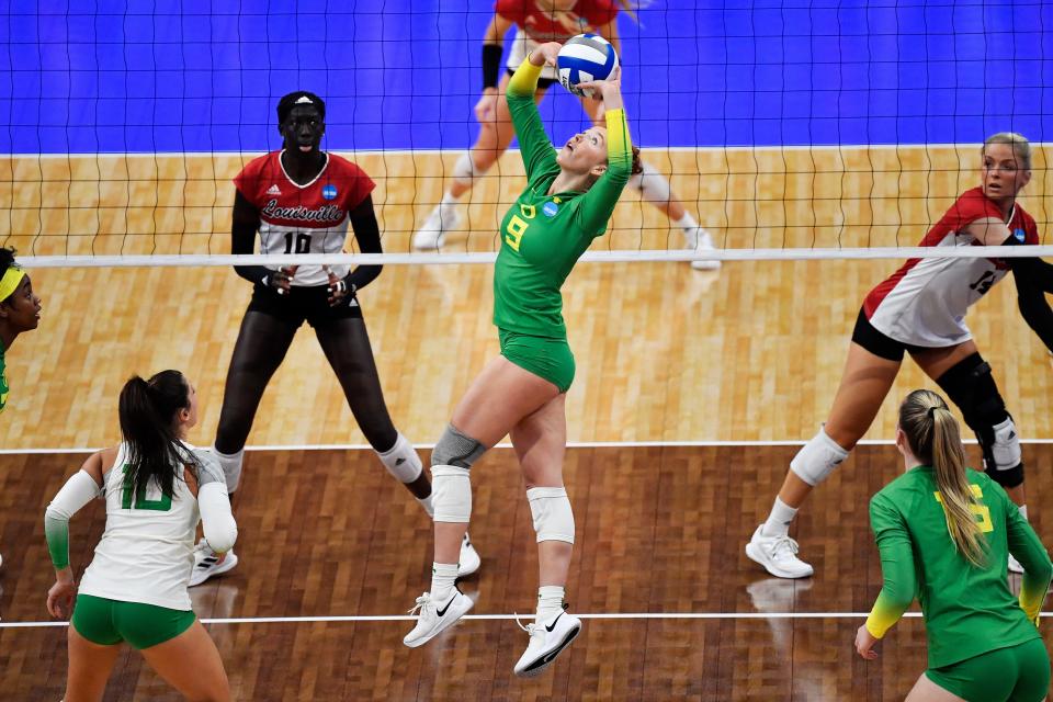 Oregon's Hannah Pukis (9) sets the ball for her teammates during their NCAA Regional Final game, Saturday, Dec. 10 2022 in Louisville Ky.