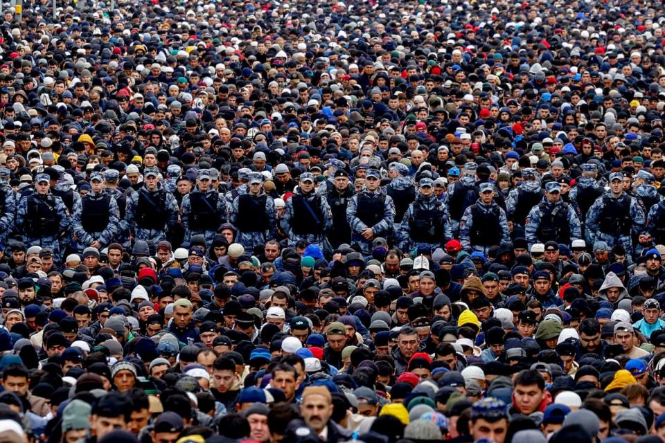 Russian riot police stand guard as Muslims gather to perform the Eid al-Fitr prayer at the courtyards of the Anit Mosque and Historical Mosque in Moscow, Russia on May 2, 2022. (Sefa Karacan/Anadolu Agency via Getty Images)