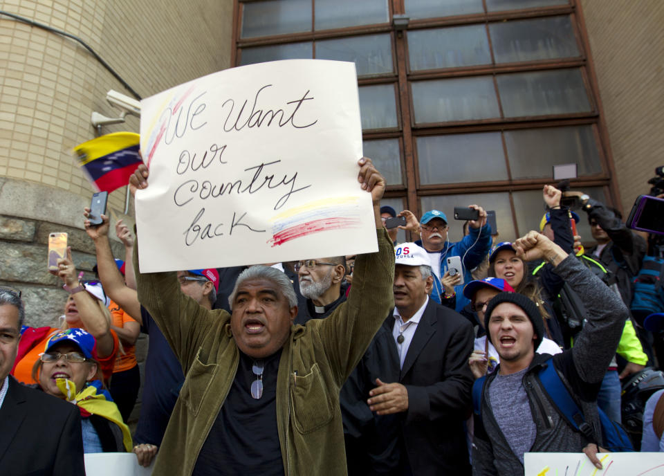 Opposition leader Juan Guaido supporters celebrate during the eviction and arrest of Nicolas Maduro's supporters from the Venezuelan Embassy in Washington, Thursday, May 16, 2019. (AP Photo/Jose Luis Magana)