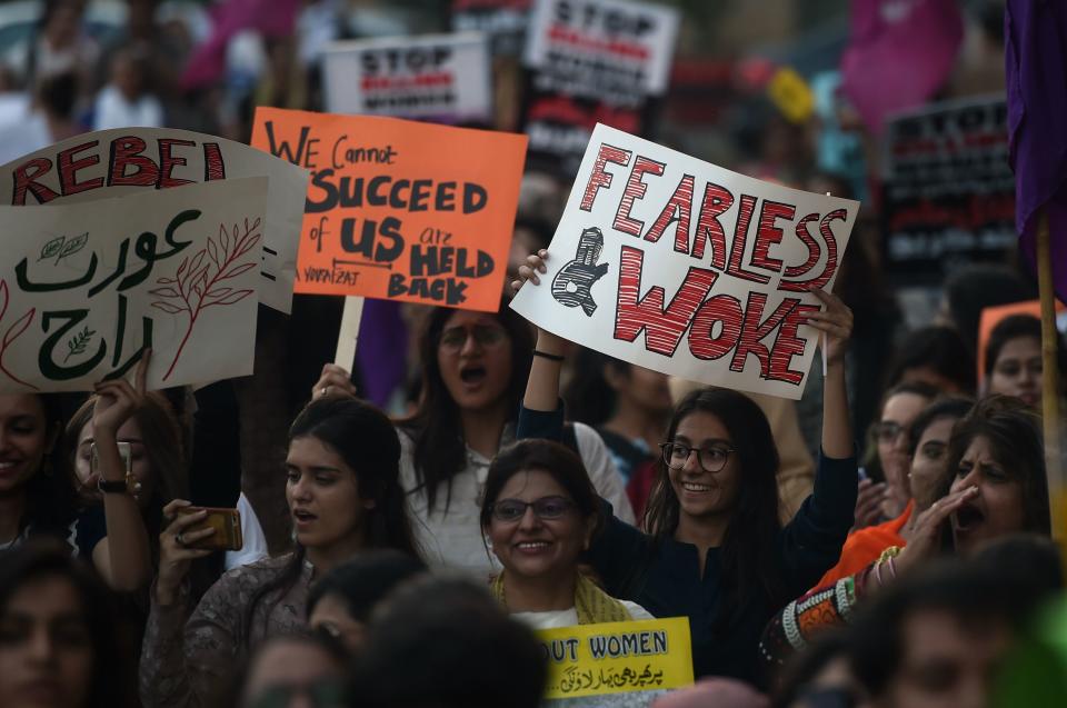 Pakistani civil society activists carry placards as they march during a rally.