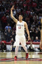 San Diego State forward Nolan Narain gestures after hitting a 3-point shot during during the first half of the team's NCAA college basketball game against Colorado State on Tuesday, Feb. 25, 2020, in San Diego. (AP Photo/Denis Poroy)