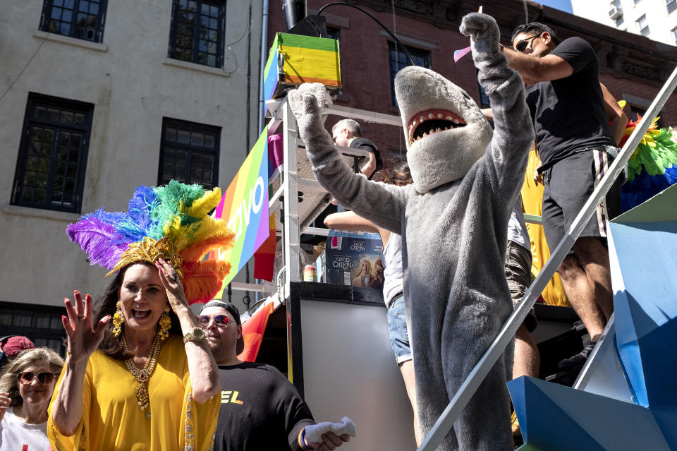 A float with participants aboard passes near the Stonewall Inn during the LBGTQ Pride march Sunday, June 30, 2019, in New York. (AP Photo/Craig Ruttle)