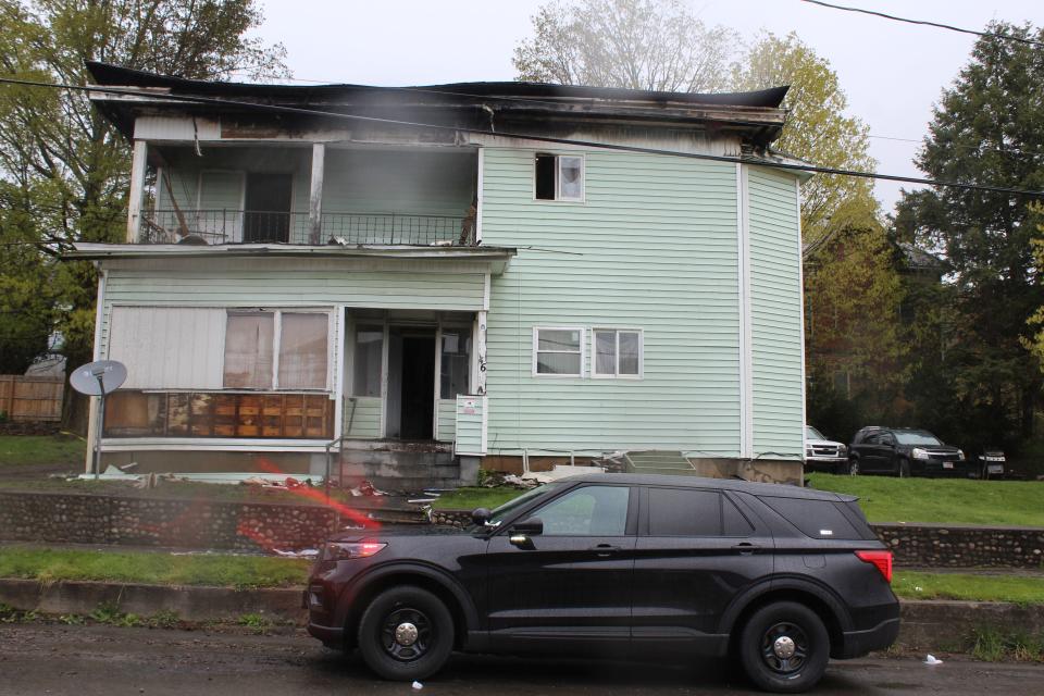 A Wellsville Police cruiser sits outside 46 N. Broad St. Tuesday morning in the aftermath of a structure fire at the four-unit apartment building.