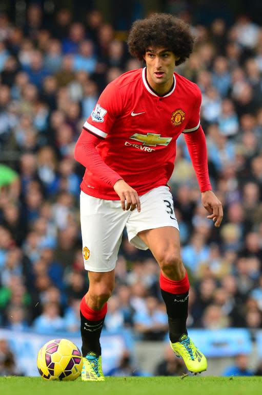 Manchester United's Belgian midfielder Marouane Fellaini runs with the ball during the English Premier League football match against Manchester City in Manchester, England on November 2, 2014