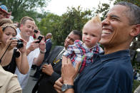 President Barack Obama holds a baby while greeting guests during an Independence Day celebration on the South Lawn of the White House on July 4, 2012 in Washington, D.C. (Pete Souza/White House Photo via Getty Images)