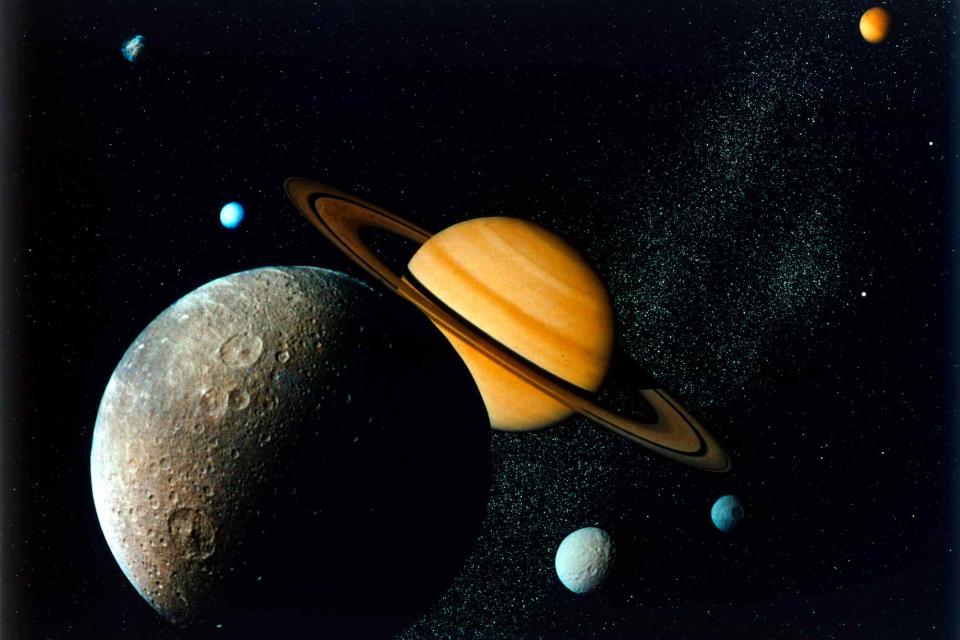 <p>Heritage Space/Heritage Images/Getty </p> Stock image of Saturn and its moons