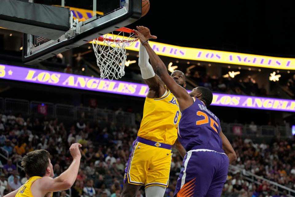 Los Angeles Lakers forward LeBron James (6) blocks a shot by Phoenix Suns forward Mikal Bridges (25) during the first half of a preseason NBA basketball game Wednesday, Oct. 5, 2022, in Las Vegas.