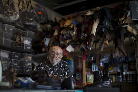 Owner Arturo Azinian poses for a portrait in his shoe repair shop in Beverly Hills, California April 24, 2015. REUTERS/Mario Anzouni