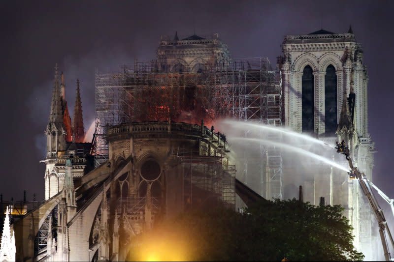 Firefighters battle to extinguish a giant fire that engulfed Paris' Notre Dame Cathedral on April 16, 2019. Photo by Eco Clement/UPI