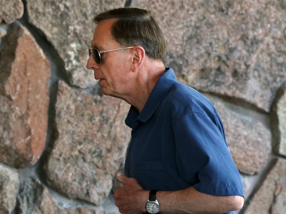 David Petraeus walks holding smartphone at Sun Valley