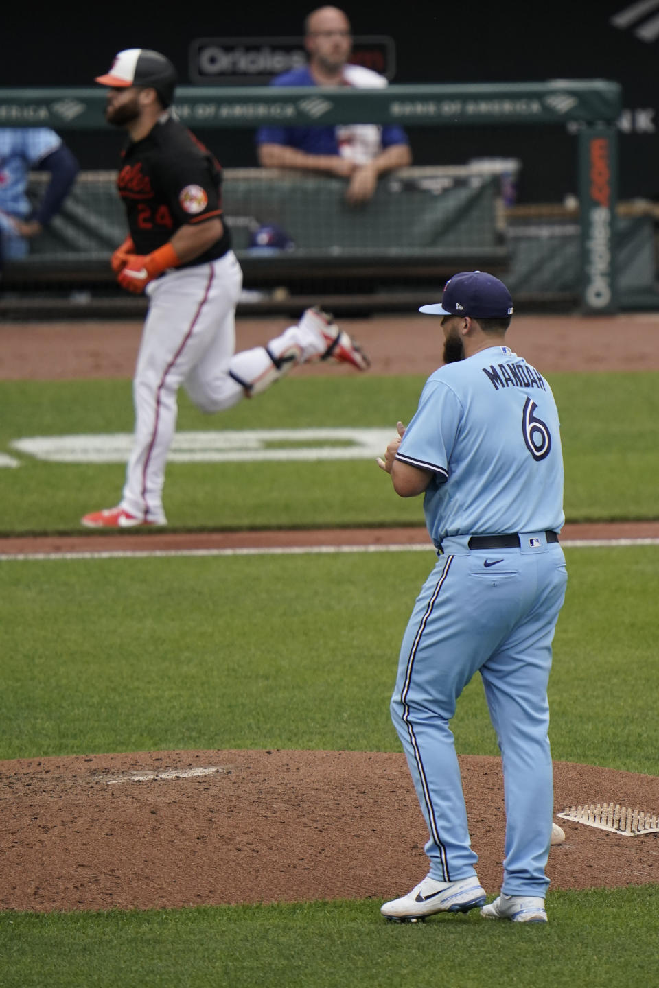 Toronto Blue Jays starting pitcher Alek Manoah (6) looks on as Baltimore Orioles' DJ Stewart runs the bases after hitting a solo home run off him during the fourth inning of a baseball game, Saturday, June 19, 2021, in Baltimore. (AP Photo/Julio Cortez)