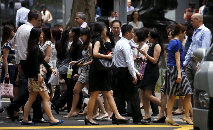 Officer workers seen in Singapore’s central business district. (PHOTO: Reuters)