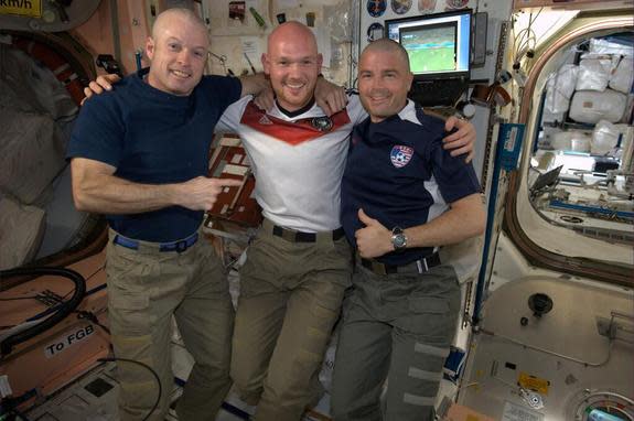 From left to right: NASA's Steve Swanson, German astronaut Alexander Gerst and NASA's Reid Wiseman line up after Gerst shaved both NASA astronauts' heads to even a bet the NASA astronauts lost after the United States lost to Germany in a World