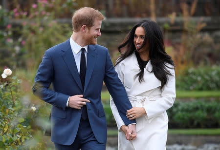 FILE PHOTO: Britain's Prince Harry poses with Meghan Markle in the Sunken Garden of Kensington Palace, London, Britain, November 27, 2017. REUTERS/Toby Melville/File Photo