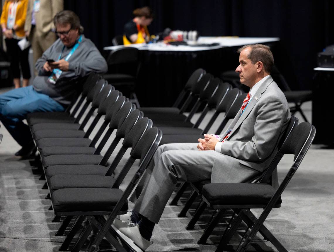 ACC Commissioner Jim Phillips watches N.C. State coach Kevin Keatts, during his post game press conference following the Wolfpack’s loss to Purdue in the NCAA Final Four National Semifinal game on Saturday, April 6, 2024 at State Farm Stadium in Glendale, AZ. Robert Willett/rwillett@newsobserver.com