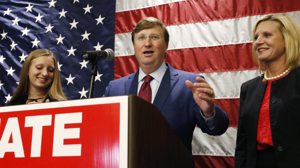 Lt. Gov. Tate Reeves, center, flanked by daughter Tyler Reeves, left, and wife, Elee Reeves, celebrates after being declared winner of the runoff for the Republican nomination for governor in Jackson, Miss., Tuesday evening, Aug. 27, 2019. Reeves beat former Mississippi Supreme Court Chief Justice Bill Waller Jr. in the runoff. (AP Photo/Rogelio V. Solis)