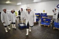 Britain's Prime Minister and Conservative Party leader Boris Johnson, center, visits Grimsby fish market in Grimsby, northeast England, Monday Dec. 9, 2019, ahead of the general election on Dec. 12. All 650 seats in the House of Commons are up for grabs Thursday when voters will pass judgement on a divisive election that will determine Britain's future with European Union. (Ben Stansall/Pool via AP)