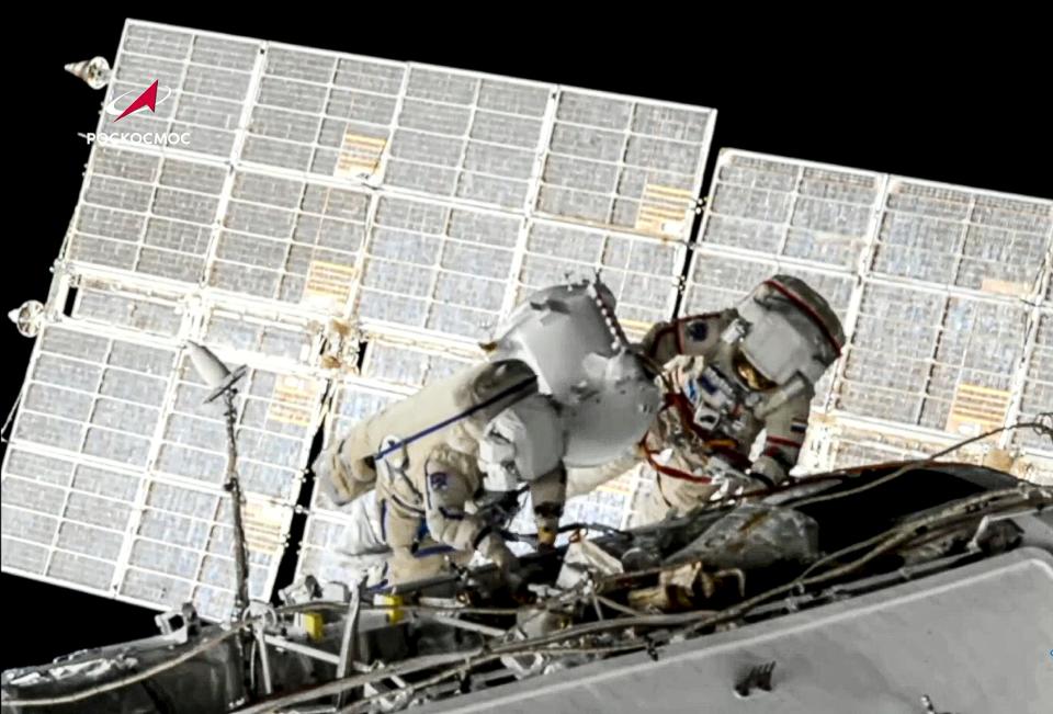 In this June 2, 2021 file image taken from Roscosmos video, Russian cosmonauts Oleg Novitsky, right, and Pyotr Dubrov, members of the crew to the International Space Station (ISS), perform their first spacewalk to replace old batteries outside the International Space Station.