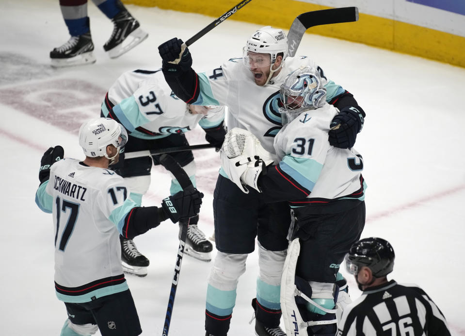 From left, Seattle Kraken center Jaden Schwartz, defenseman Jamie Oleksiak and goaltender Philipp Grubauer celebrate as time runs out in the third period of Game 7 of an NHL first-round playoff series against the Colorado Avalanche Sunday, April 30, 2023, in Denver. The Kraken won 2-1 to advance to the next round. (AP Photo/David Zalubowski)