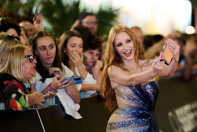 <p>Carlos Alvarez/Getty</p> Jessica Chastain was also kind enough to pose with fans and take selfies