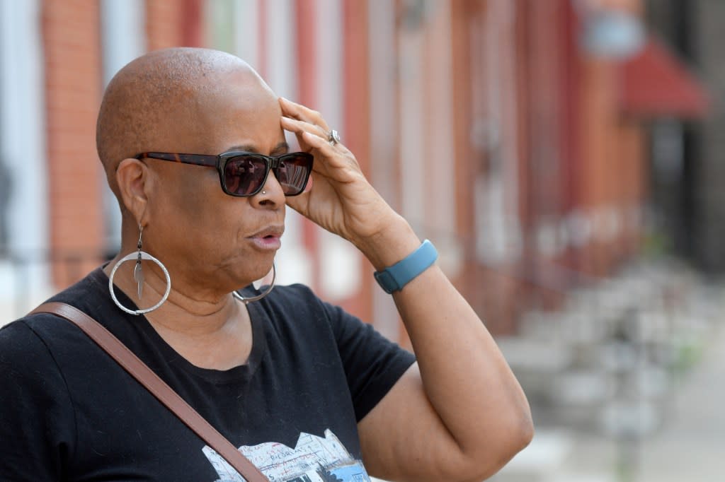 Gloria Webster, of Raleigh, N.C., stands on her old street in Baltimore, on Thursday, June 15, 2023. She lived down the block from St Martin, the Catholic church where her daughter was abused decades ago by their parish priest. (AP Photo/Steve Ruark)