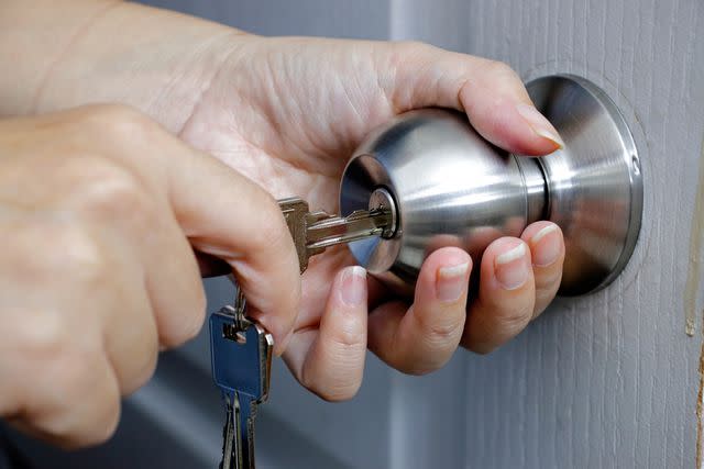 <p>Getty</p> Stock image of a person opening a door with a key