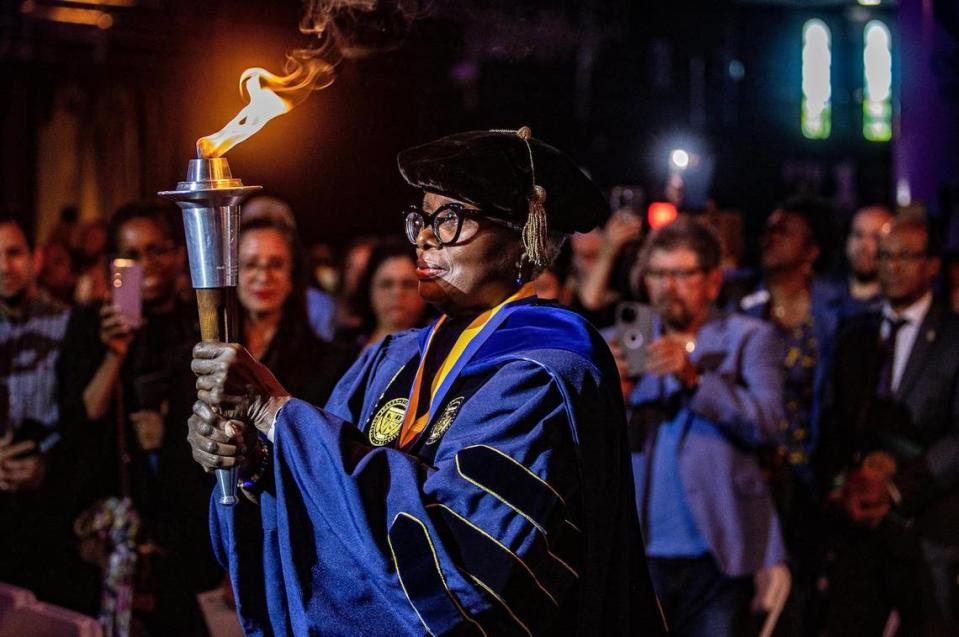 FIU professor Valerie Patterson carries the Torch of Knowledge during the presidential investiture ceremony of Kenneth Jessell, Florida International University’s sixth president, Thursday May 18 , 2023.