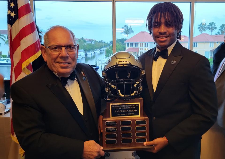 Palmetto Ridge senior Jhordan Inniss (right) accepts the Leadership Award from National Football Foundation Collier County Chapter president Matt Sellitto at the group's scholarship banquet on April 10, 2021, at the Naples Sailing and Yacht Club.