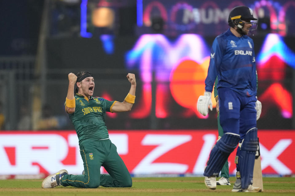 South Africa's Gerald Coetzee, left, celebrates the dismissal of England's Harry Brook during the ICC Men's Cricket World Cup match between South Africa and England in Mumbai, India, Saturday, Oct. 21, 2023. (AP Photo/ Rafiq Maqbool)