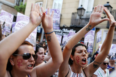 Protesters attend a demonstration against the release on bail of five men known as the "Wolf Pack" cleared of gang rape of a teenager and convicted of a lesser crime of sexual abuse in Madrid, Spain, June 22, 2018. REUTERS/Susana Vera