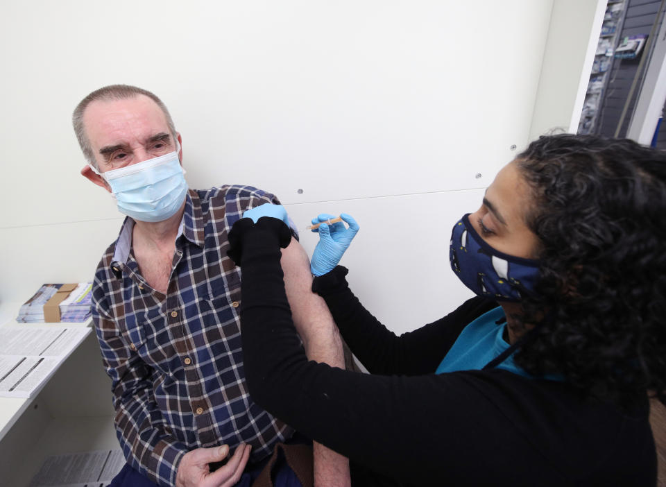 Pharmacist Asha Fowells vaccinates Barrie Reader, aged 74, with his first dose of the Oxford/AstraZeneca coronavirus vaccine, at Copes Pharmacy and Travel Clinic in Streatham, south London. Picture date: Thursday February 4, 2021.