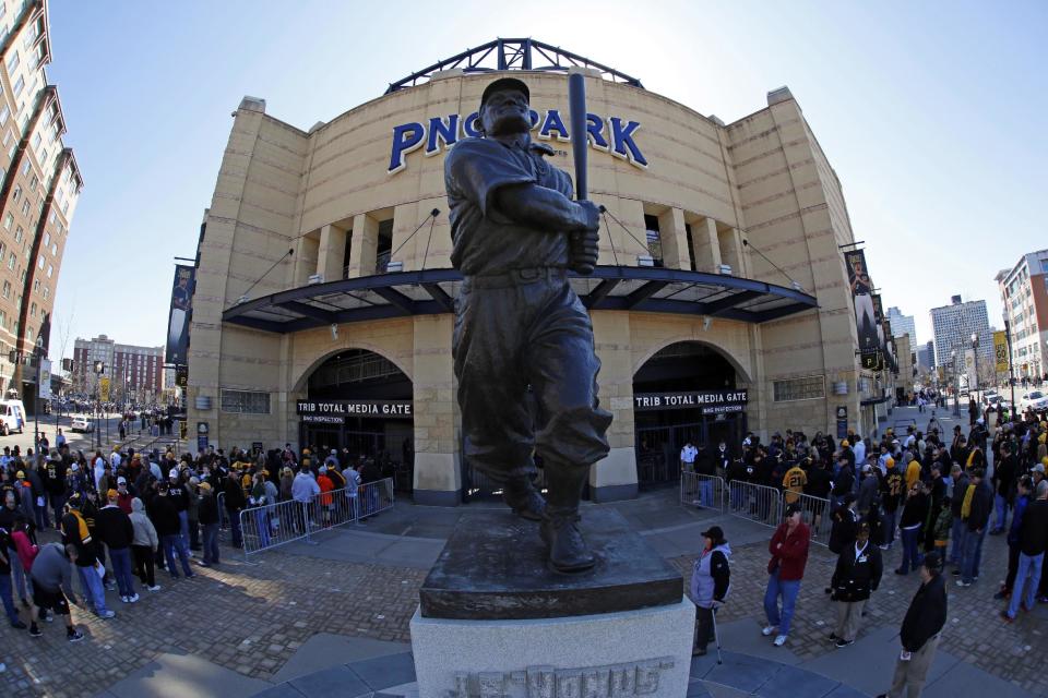 Baseball fans line up outside PNC Park near the statue of Hall of Fame Pittsburgh Pirates shortstop Honus Wagner before the opening day baseball game between the Pittsburgh Pirates and the Chicago Cubs on Monday, March 31, 2014, in Pittsburgh. (AP Photo/Gene Puskar)