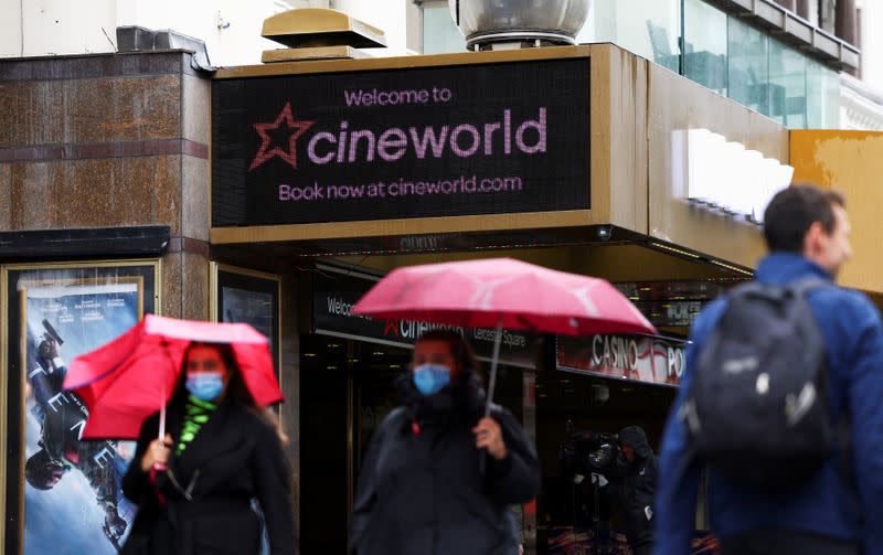 FILE PHOTO: People walk past a Cineworld in Leicester's Square in London