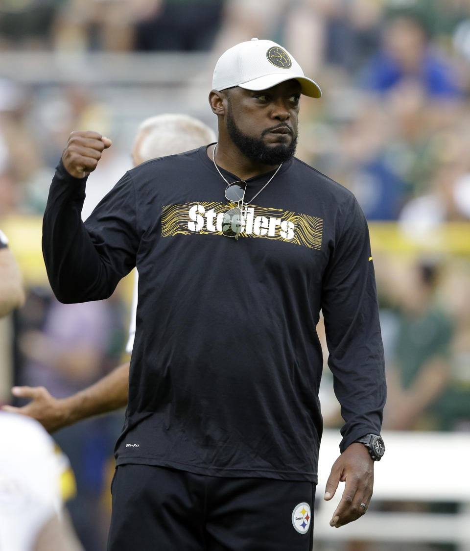 FILE - In this Aug. 16, 2018, file photo, Pittsburgh Steelers head coach Mike Tomlin watches warm ups before a preseason NFL football game against the Green Bay Packers, in Green Bay, Wis. As long as Mike Tomlin is standing on the Pittsburgh sideline, watching Ben Roethlisberger pass to Antonio Brown or stick the ball in the stomach of Le’Veon Bell, the Steelers will be favored to win the AFC North. (AP Photo/Jeffrey Phelps, File)