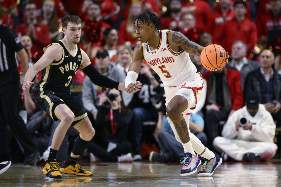 Maryland guard DeShawn Harris-Smith (5) dribbles the ball as Purdue guard Braden Smith (3) defends during the first half of an NCAA college basketball game Tuesday, Jan. 2, 2024, in College Park, Md. (AP Photo/Nick Wass)