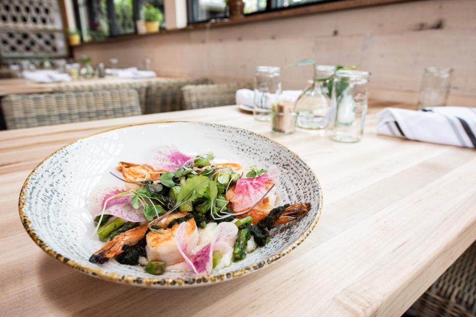 Terrain's seasonally-inspired menu includes farm-to-table dishes, such as Shrimp & Heirloom Grits with asparagus, radish and pickled jalepeño basil honey.