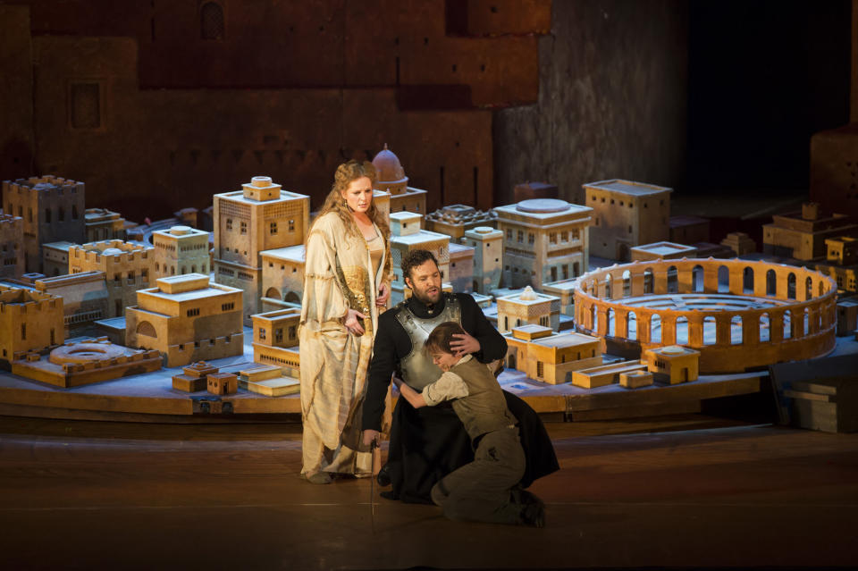 In this image released by the Royal Opera house in London on Monday, June 25, 2012 shows the cast members of the opera Les Troyens, Eva-Maria Westbroek, playing Dido, left, Bryan Hymel playing Aeneas, centre, and Barbara Senator playing Ascanius taken on Wednesday, June 20, 2012. The version by director David McVicar which premiered Monday, June 25 marks the first time the company has performed the full opera in 40 years. It's an official event of the London 2012 Festival being held in conjunction with the Olympics _ and set designer Es Devlin is also designing the closing ceremony for the Games. (AP Photo/Bill Cooper, Royal Opera House)